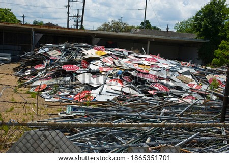Street signs and stop signs. Piles of broken stop signs and road signs photographed in a junk yard.