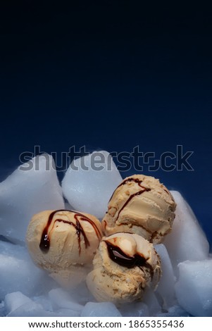 caramel ice cream scoops with chocolate sauce on dry ice