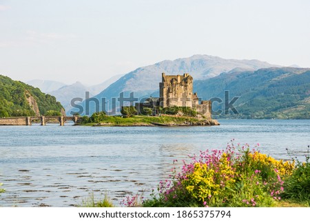 Eilean Donan Castle picture form the distance with sunset light at spring time