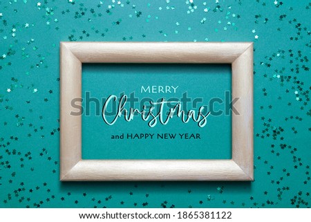 Merry Christmas congratulations photo frame with many green shiny stars on green paper background