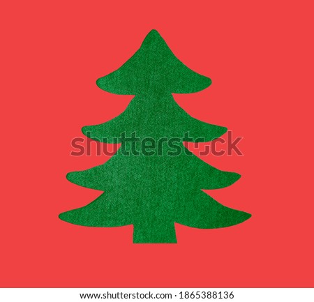 green jeans fabric  in the form of Christmas tree. 2021 happy new year and merry christmas. isolated on red background.