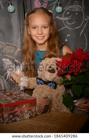 Cute winter fairy tale girl with. Girl with teddy bear and a box of gifts. Christmas mood. Christmas  decorations over dark background. Beautiful happy little girl smiling. self-isolation holiday