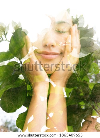 A portrait of a young woman with eyes closed with half a smile, holding her chin with hands against white background combined with a photo of large green leaves in a double exposure technique