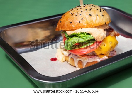 Close up tasty burger with different filling served on tray