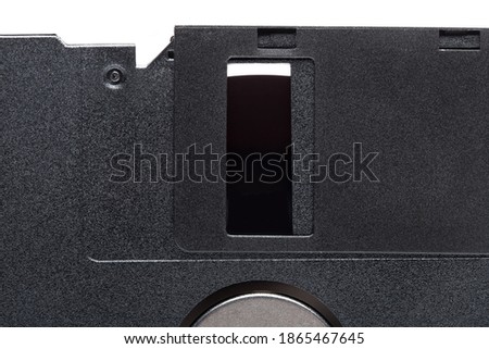 floppy diskette in a black square plastic case with open magnetic disk, obsolete computer technology device memory carrier 90s isolated on white background, close up view, nobody.