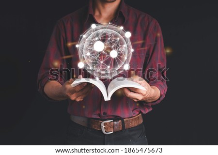 A man is working with a laptop. The other hand holds the globe, graphics, and stock chart. Investment ideas, business concepts, technology concepts.