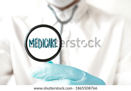 Doctor holding a stethoscope with text MEDICARE, medical concept