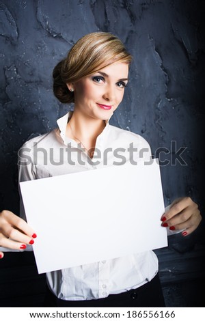 Businesswoman holding a white poster and smiling. Photo toned style instagram filters 