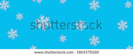 Christmas pattern of white snowflakes on a blue background. Concept banner frame border background for Christmas and New Year
