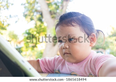 Little asian girl sitting watching digital tablet.It's learning for modern kids, but it can have a negative impact on children's eyes and reflexes.