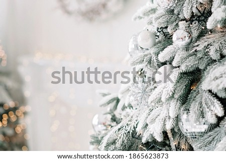 Christmas minimal background, a Christmas tree decorated with balls on a background of blurry bokeh lights. Baner, holiday card, mockup. New Year 2021. Soft selective focus, copy space.