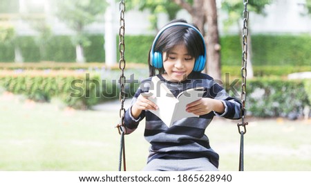 introvert mindset in digital generation of asian kids happy with music in earphone and stay alone in park 