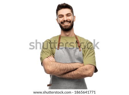 people, profession and job concept - happy smiling barman in apron with crossed arms over white background Royalty-Free Stock Photo #1865641771