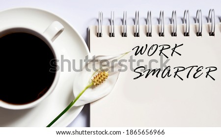 WORK SMARTER , planning concept. notebook with text on the white background with coffee