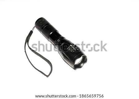 (police flashlight) flashlight on isolated white background. flashlight that can zoom in and zoom out the light distance