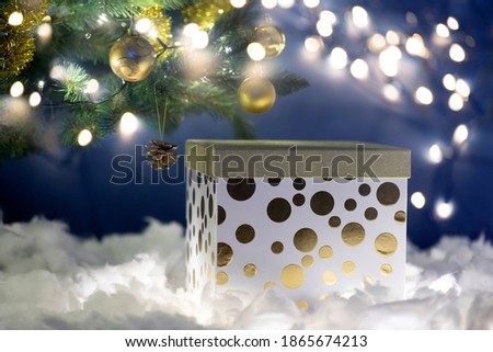 Christmas gift boxe against bokeh of twinkling party lights. Christmas background with gift box. Christmastime celebration.