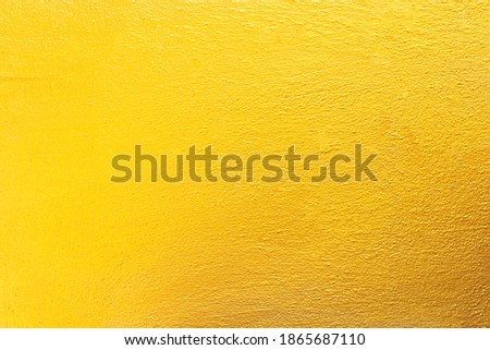 Gold concrete wall texture or background  and copy space
