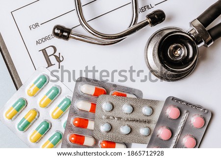 Medical concept with stethoscope, pills, notepad, pen on the doctor desktop