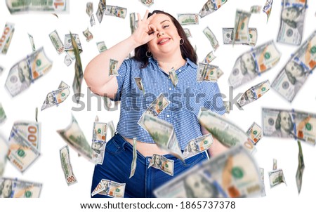 Young plus size woman wearing casual clothes smiling happy doing ok sign with hand on eye looking through fingers