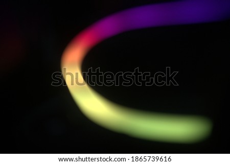 blurry background pic two, swirly  linear colorful rounded lights pattern  on black 