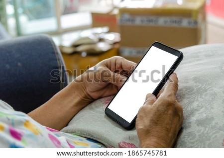 woman holding blank  white screen mock up mobile phone in hand.
