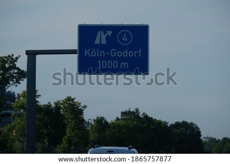 view of a sign for distances on a freeway
