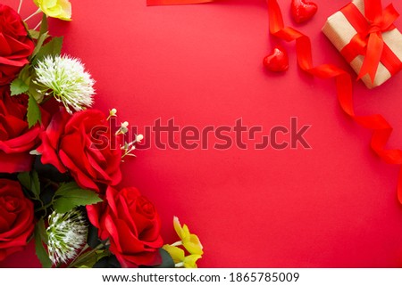 Flowers on red background with red ribbon, copy space for text