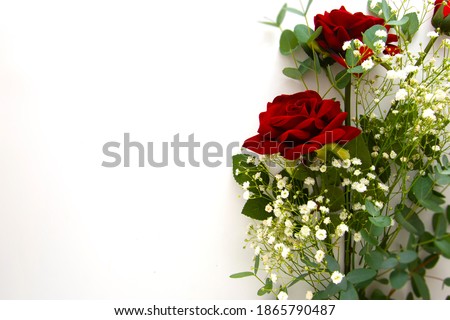 Flower composition from red rose and gypsophila flower eucalyptus branches and leaves isolated on white