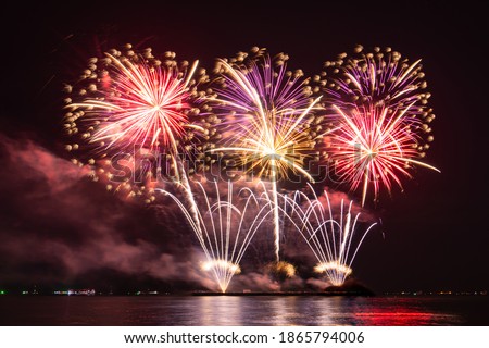 Colorful of fireworks In the sea display on sky background, for New Year, party or any celebration event