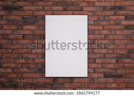 Blank poster on brick wall. Mockup for design 