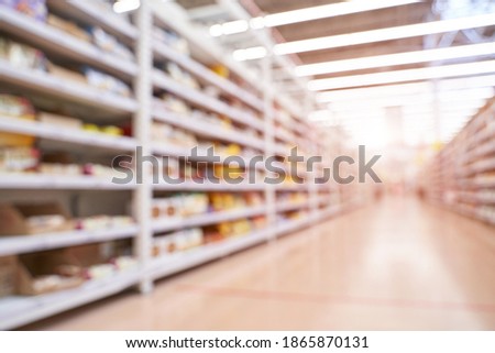Food market interior. Blur corridor light background. Shop shelf. Stock cold goods. Refrigerator storage. Perspective grocery hall. Supermarket wallpaper. Copyspace. Milk product