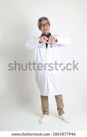 The senior Asian physician on the white background.