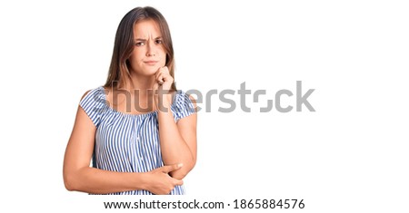 Beautiful caucasian woman wearing casual clothes serious face thinking about question with hand on chin, thoughtful about confusing idea 