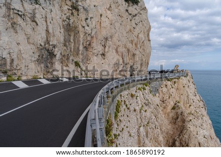 The stunning high altitude cliffside road along the coastline of Liguria, Italy  Royalty-Free Stock Photo #1865890192