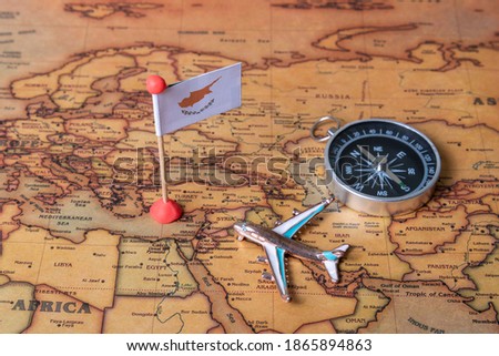 Cyprus flag, compass and plane on the world map. The concept of travel and tourism.