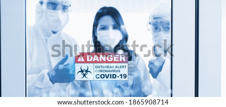 Close up of danger outbreak alert coronavirus COVID-19 sign at hospital door blur medical doctor wearing protective clothing happy successful in treatment healthcare woman is patient pandemic virus.