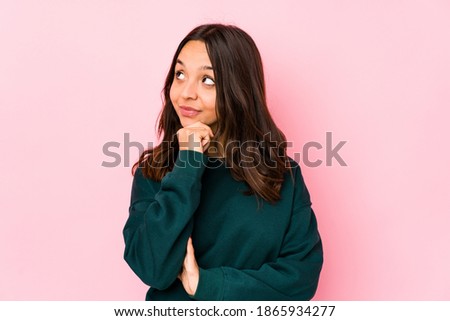 Young mixed race hispanic woman isolated looking sideways with doubtful and skeptical expression.