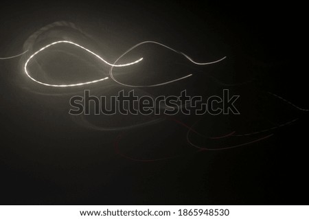 Abstract background. Glowing lines in the dark