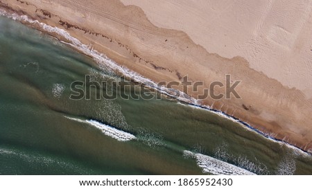 
The waves reach the coast seen from the air, leaving beautiful textures Royalty-Free Stock Photo #1865952430