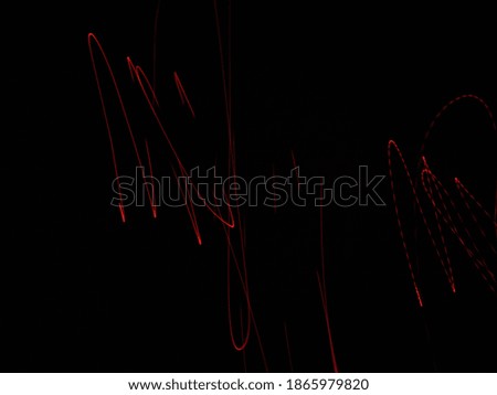 Red and orange colored abstract light painting photography in black background