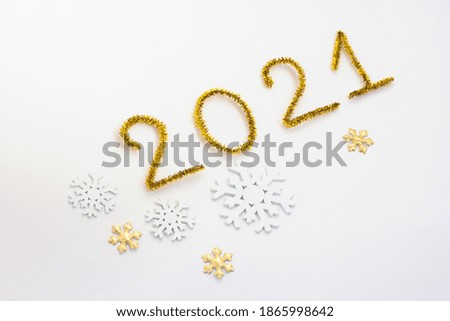 2021 number for New year greeting card. Christmas Party decoration on white background. Golden tinsel and snowflakes