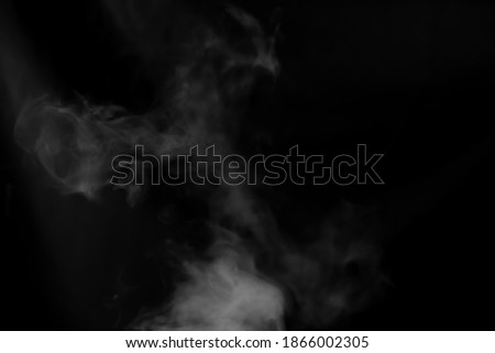 Blurred picture of white smoke on black background. 