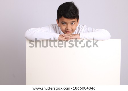 Young Indian schoolboy showing blank copy space.