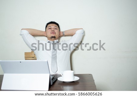 Tired and stressed young businessman working at his computer