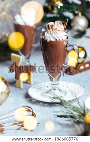 Hot chocolate with wiped cream on top in Christmas decoration. Festive and holiday mood and atmosphere