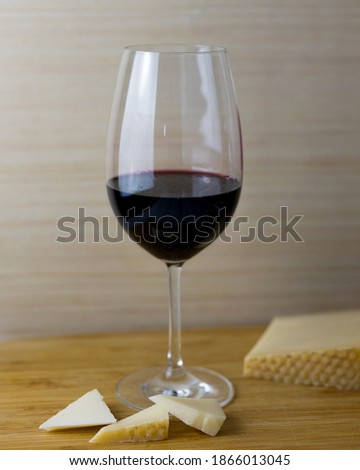 glass of the red wine with cheese