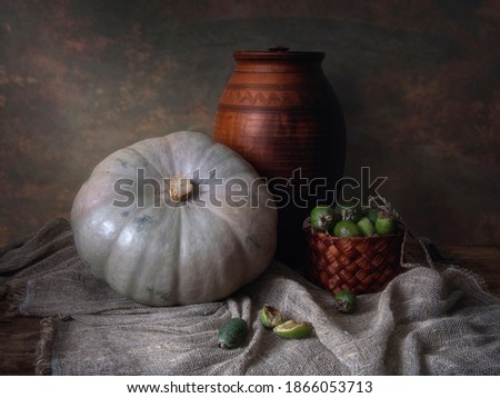 Still life with pumpkin and green berry