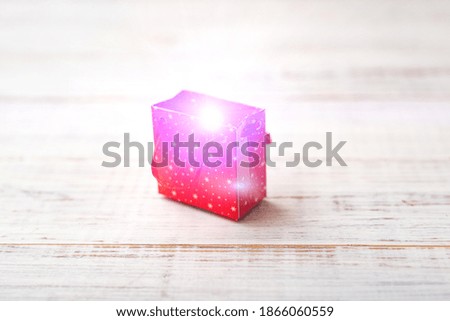 Gift giving. Bright little gift on a white wooden background.