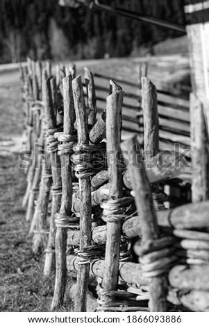 An old wooden fence on an alpine pasture.