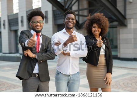 portrait of beautiful young successful people with hand gesture
